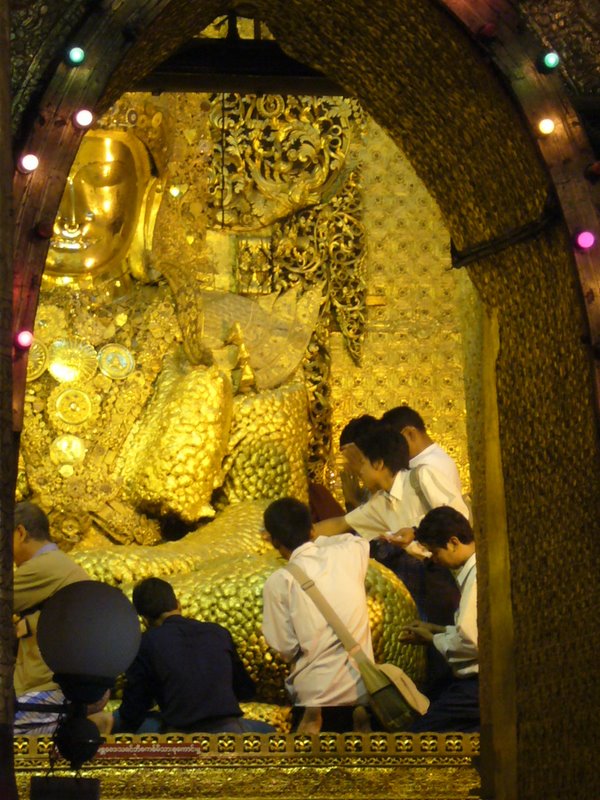 Only men are allowed to go next to it and stick more gold leaf to it!!  Who wants to go next to buddha anyway?